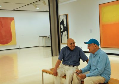 senior men at an art show